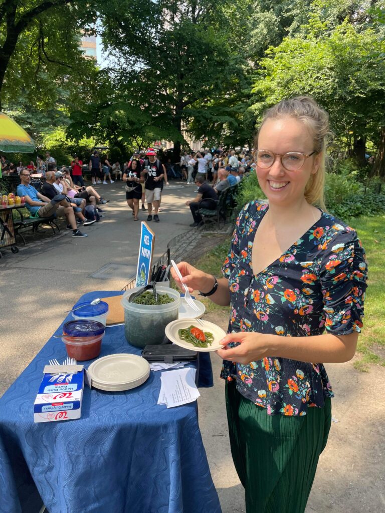 People trying Seaghetti kelp pasta samples during a public taste test in Central Park