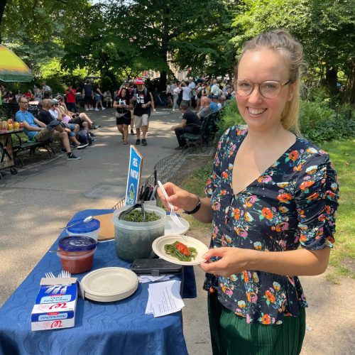 People trying Seaghetti kelp pasta samples during a public taste test in Central Park